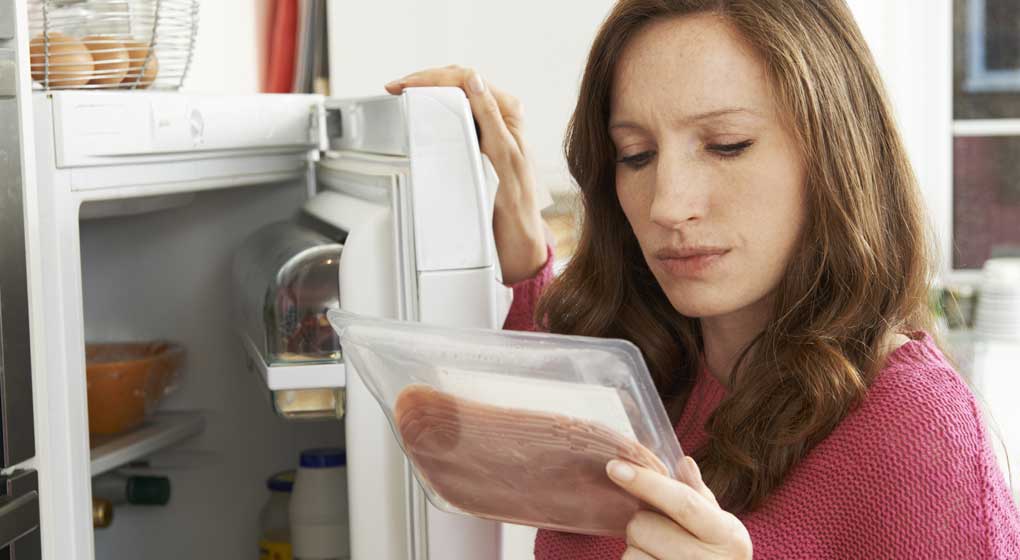 consumer studying meat packaging