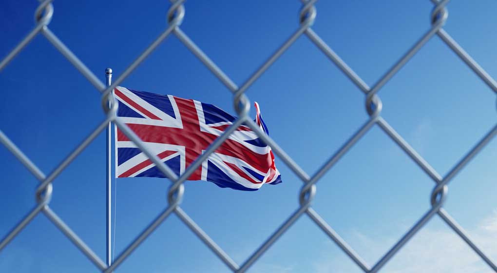 Union Jack flag behind a wire fence